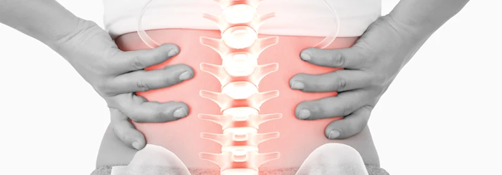 Anatomical graphic of the spine with red highlights, focusing on lower back pain and spinal stress zones.
