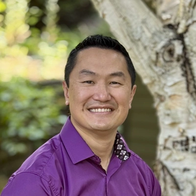 A headshot of Dr. Luther Chau, a chiropractor at Convergent Therapies.